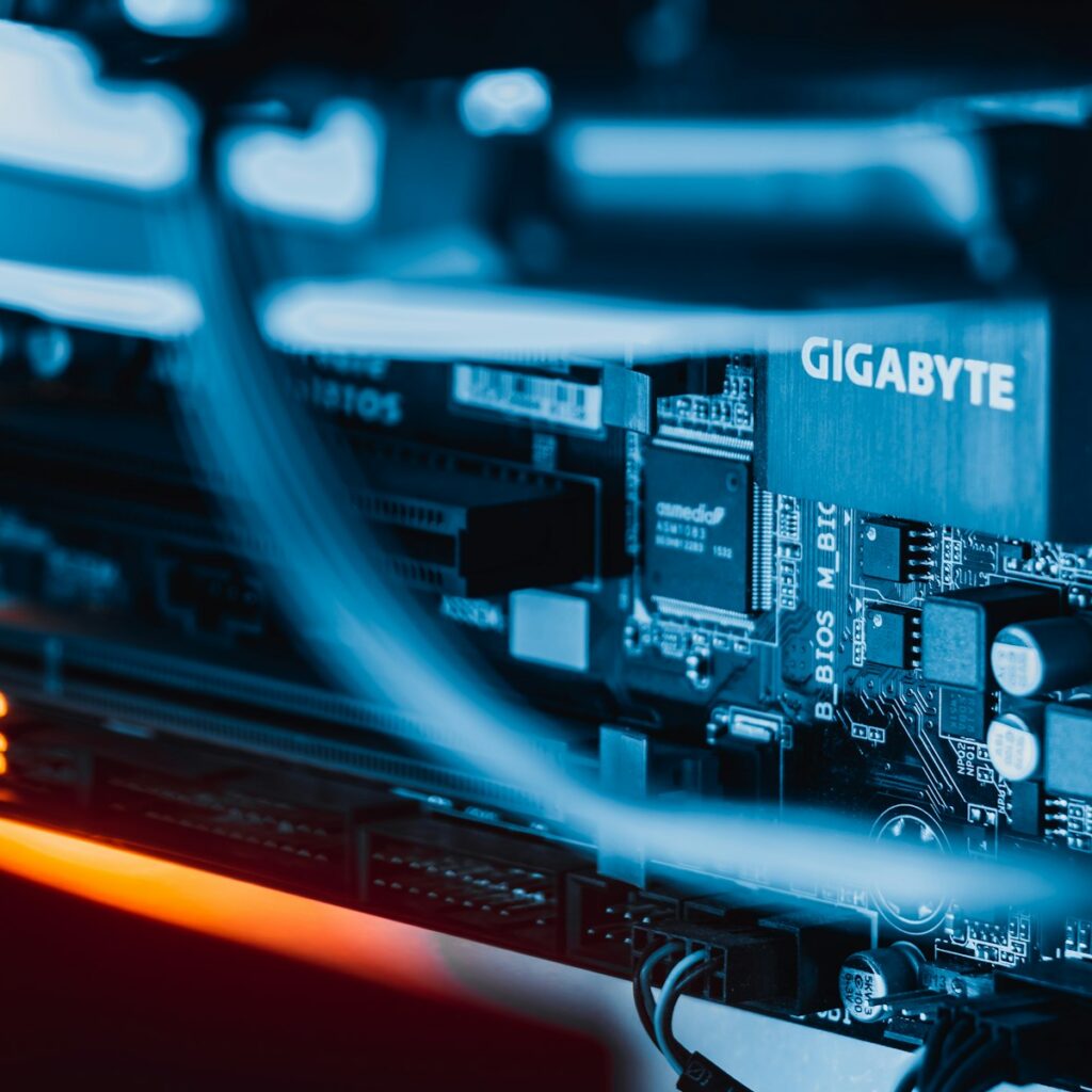 Close up of a computer motherboard glowing blue at night